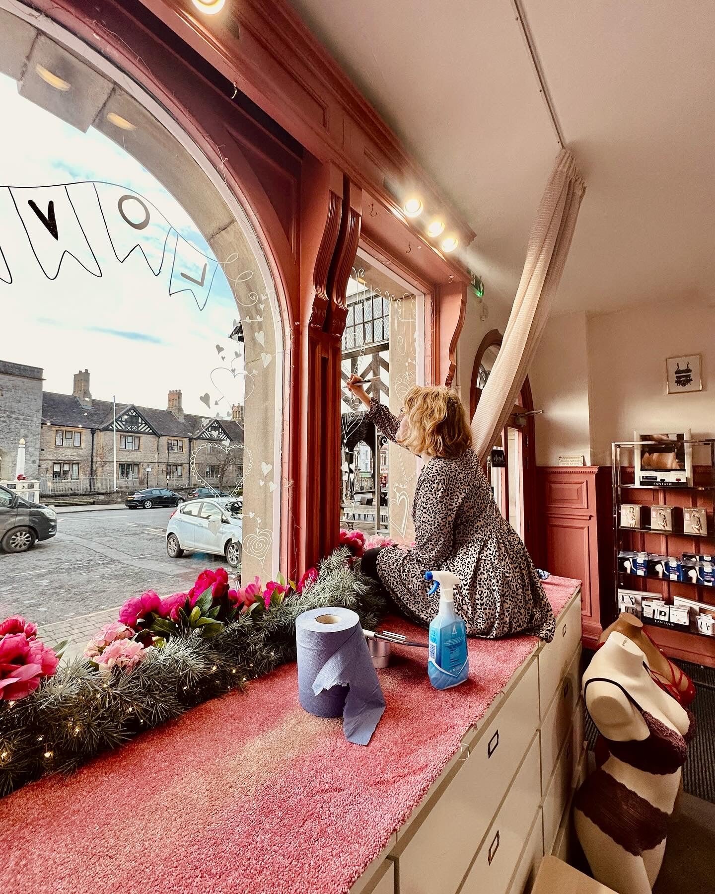 Melissa drawing art on the shop window